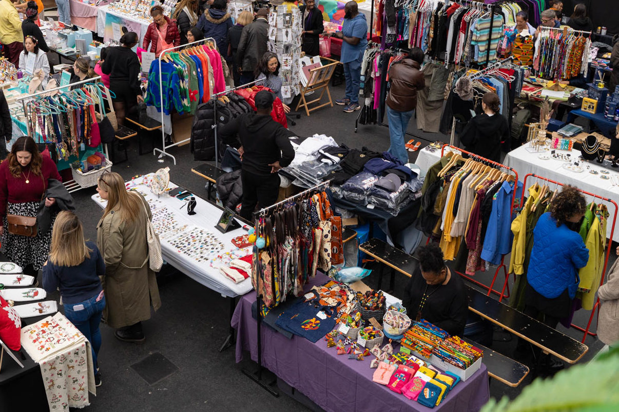 A huge crowd of people attending a craft market.